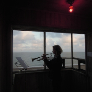 Julia Warr performing on trumpet at the top of the tower during the BROADCAST residency as part of Caro Halford's installation